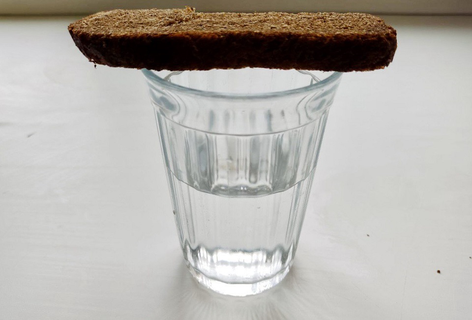 рюмка водки на столе с хлебом